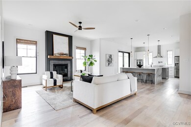 Living room featuring ceiling fan, sink, light woo