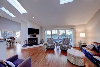 Sunfilled Living Room with Skylights and Sliders t