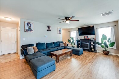 Living area featuring light wood-style flooring and a ceiling fan