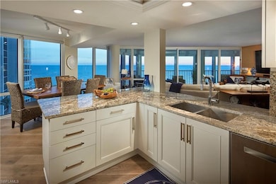 Kitchen featuring a water view, white cabinets, ki