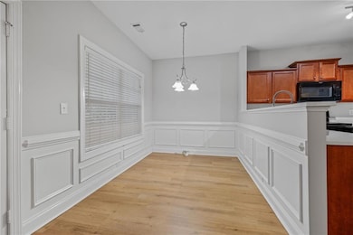 Unfurnished dining area with a sink, light wood-st