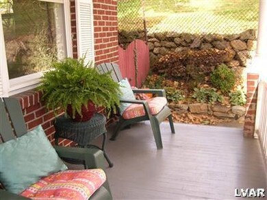 Covered front porch with entry to formal living ro