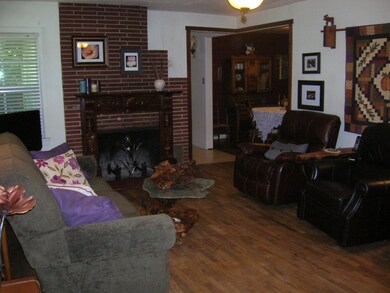 Living room w/ wood burning fireplace