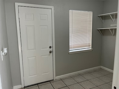 Laundry room leading to the backyard and the detached apartment