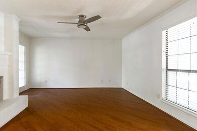 The living room windows provide a view of the balc