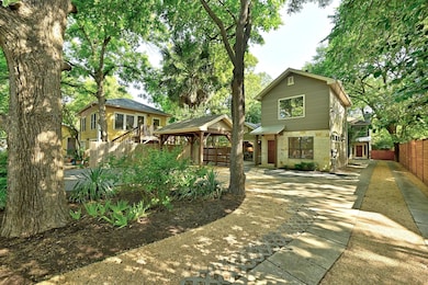 View of front facade with a gazebo, fence, and st