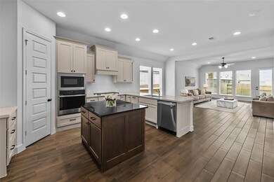 Kitchen featuring open floor plan, stainless stee