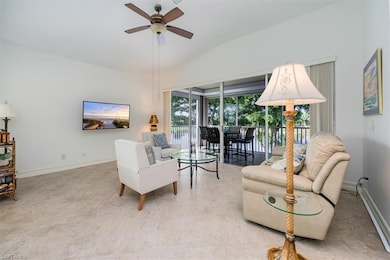 Living room featuring lofted ceiling and ceiling f