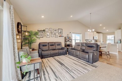 The Large Living Room With Its Vaulted Ceilings Defines Open Concept Living