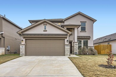View of front of house featuring stone siding, st