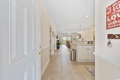 Foyer entrance featuring ornamental molding and light tile patterned flooring