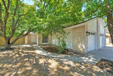 Mid-century home with stone siding and driveway