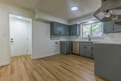 Kitchen with hardwood / wood-style flooring, gray 