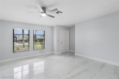 Empty room with a textured ceiling and ceiling fan