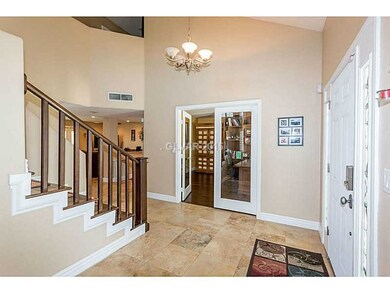 Property Photo. Entry and hardwood staircase.