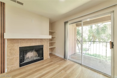 Unfurnished living room with a fireplace, wood fin