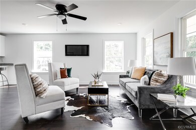 Living room with dark wood-type flooring and ceili