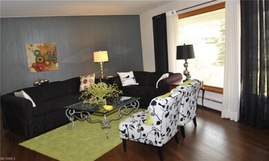 The large living room has a big picture window & d