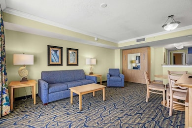 Carpeted living room featuring ornamental molding 
