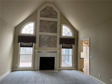 Unfurnished family room with a tiled fireplace, li