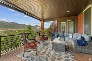Deck with an outdoor living space and a mountain view
