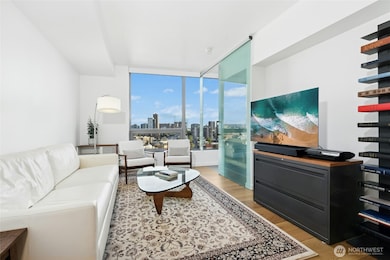 Sunlit living area with modern finishes and city views