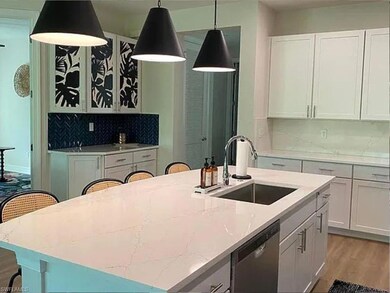 Kitchen featuring dishwasher, a sink, light wood-t