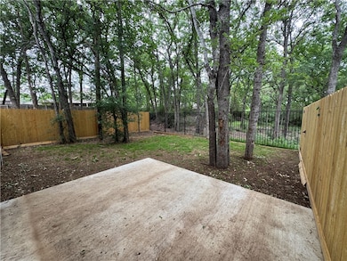 Fenced backyard with a patio