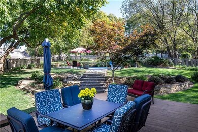 Large backyard with beautiful landscaping and unde