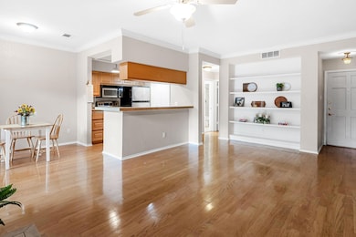 Living room featuring built in shelves, a ceiling