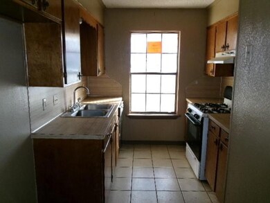 Kitchen featuring range with gas stovetop, light t