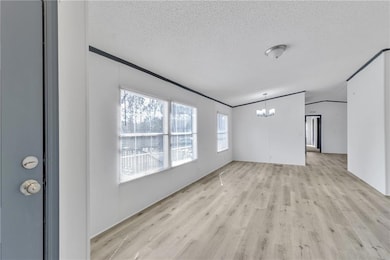 Unfurnished living room with light wood finished f