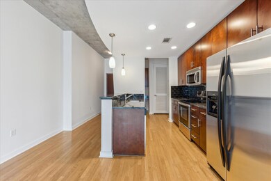 Kitchen with stainless steel appliances, light wo