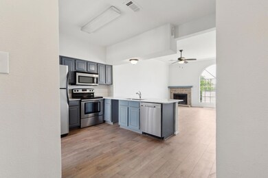 Kitchen with a ceiling fan, a sink, stainless stee