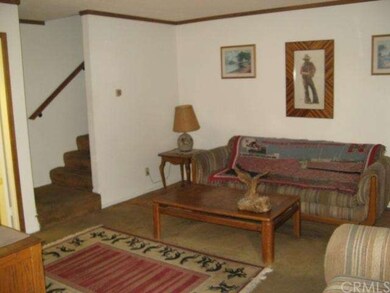 Living room with stair case heading to the two ups