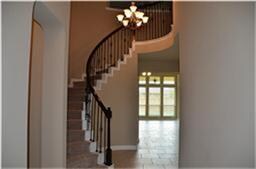 Gorgeous open foyer with spiral stair case.