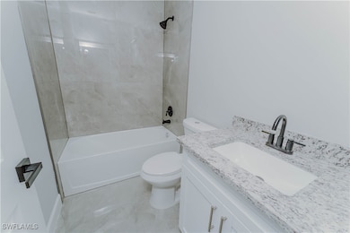 Full bathroom featuring vanity, shower / tub combi