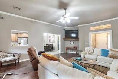Living room with dark wood-type flooring and crown