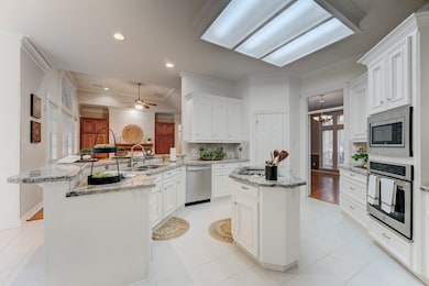Beautiful kitchen complete with granite countertops and ample cabinet space with clear view to family room