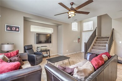 Living area with ceiling fan, visible vents, baseb