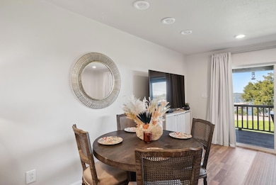 Dining area with wood-type flooring and a healthy 