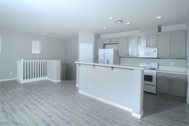 Kitchen with light wood-style floors, gray cabinet