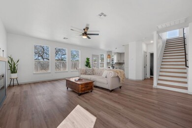 Living area featuring stairway, wood finished flo