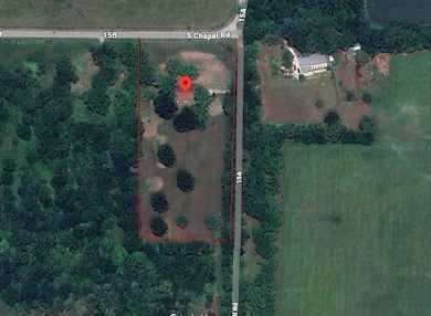 Aerial view of property and surrounding area featuring property parcel outlined