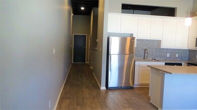 Kitchen with sink, white cabinetry, stainless stee