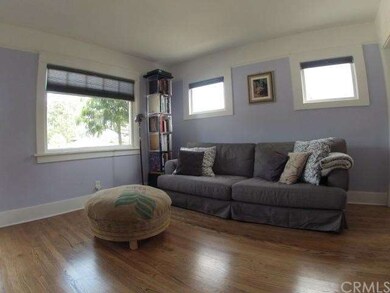 Living room corner. Original windows and wide floo