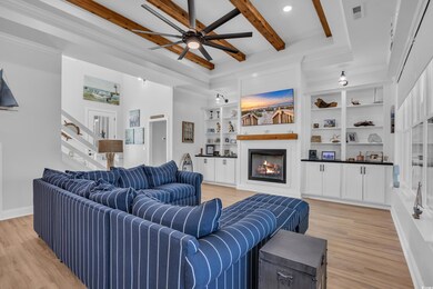 Living room with visible vents, beamed ceiling, a 