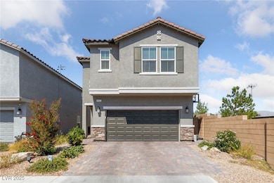 View of front of property featuring stone siding, stucco siding, decorative driveway, and a garage