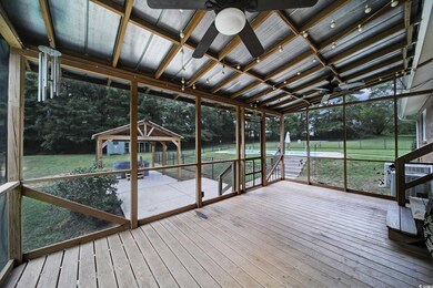 Unfurnished sunroom featuring ceiling fan