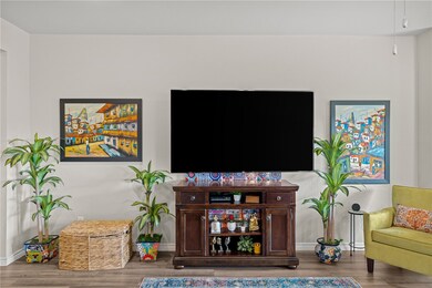 Living area featuring baseboards and wood finished